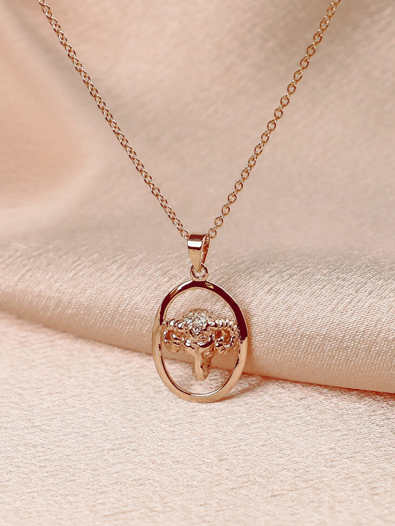 photo of aries yellow gold zodiac charm pendants necklaces on pink satin background
