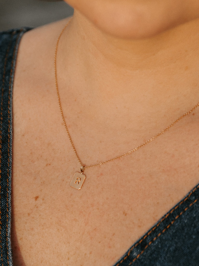 female model wearing "R" block monogram tag necklace