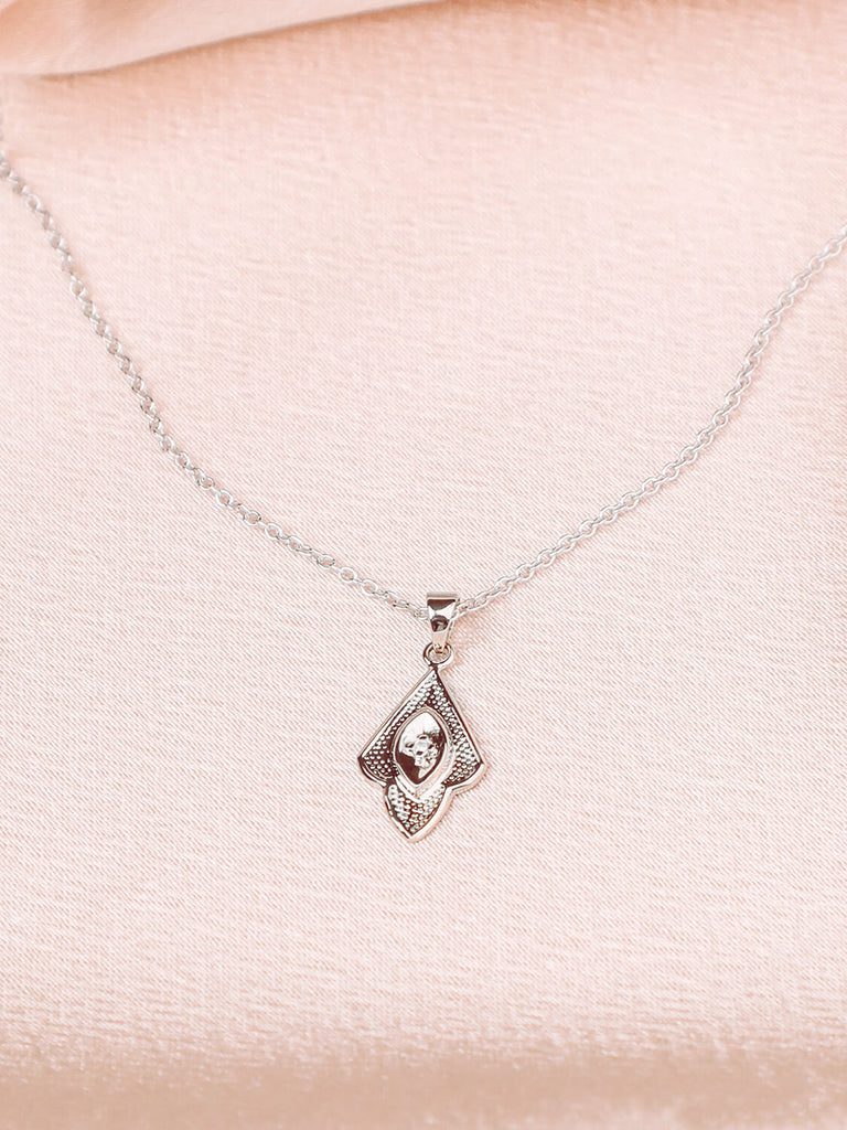detail photo of mermaid pendant in 14k white gold with diamonds