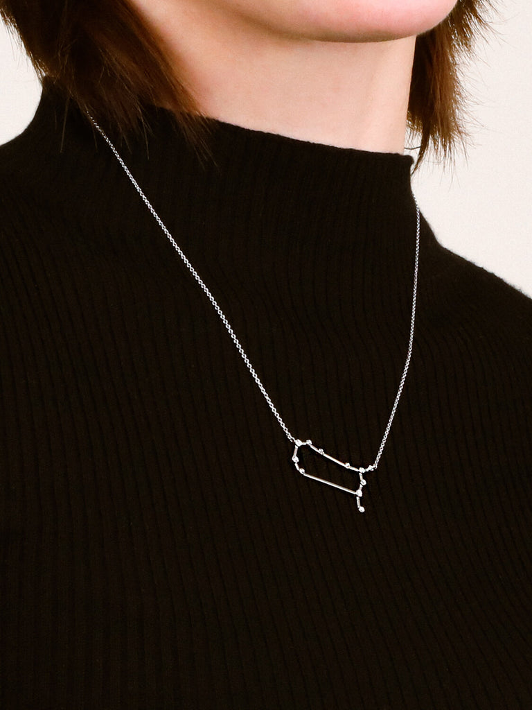 Photo of sterling silver Gemini zodiac constellation necklace from ModSet jewelry on female model's neck