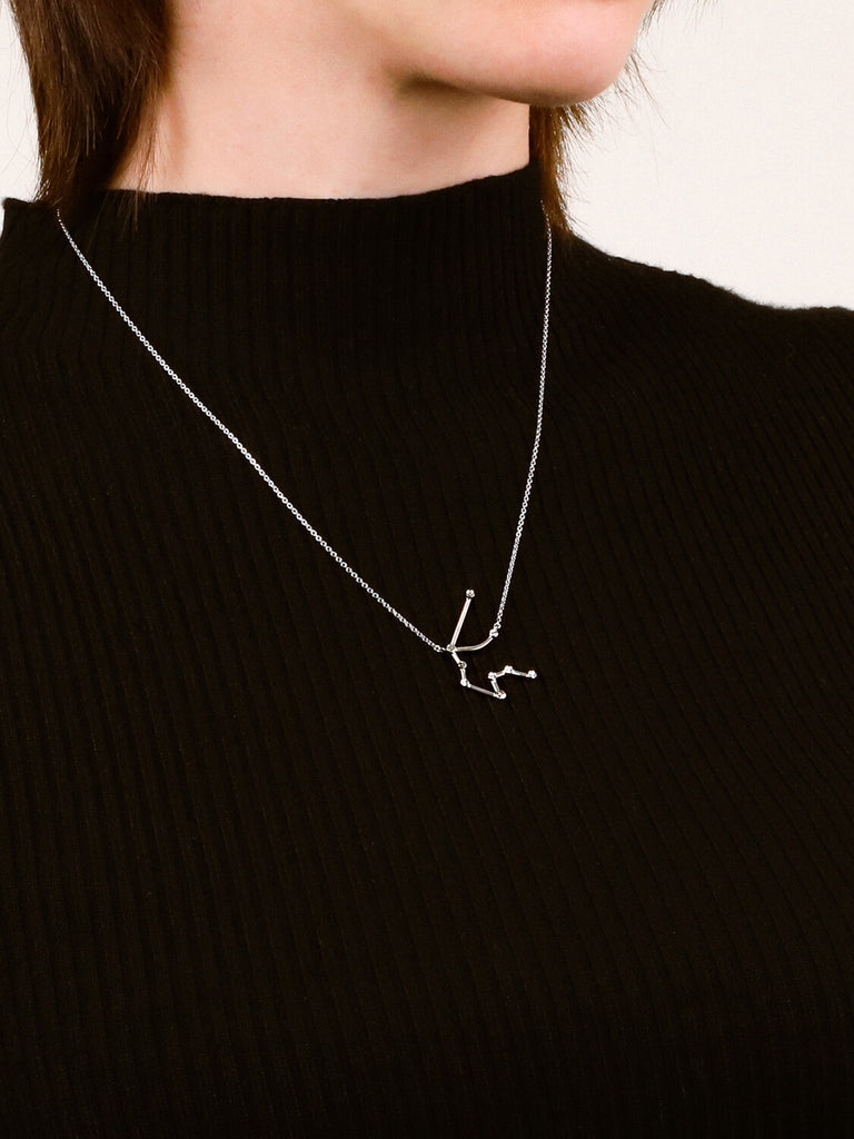 Photo of sterling silver Aquarius zodiac constellation necklace from ModSet jewelry on a woman's neck