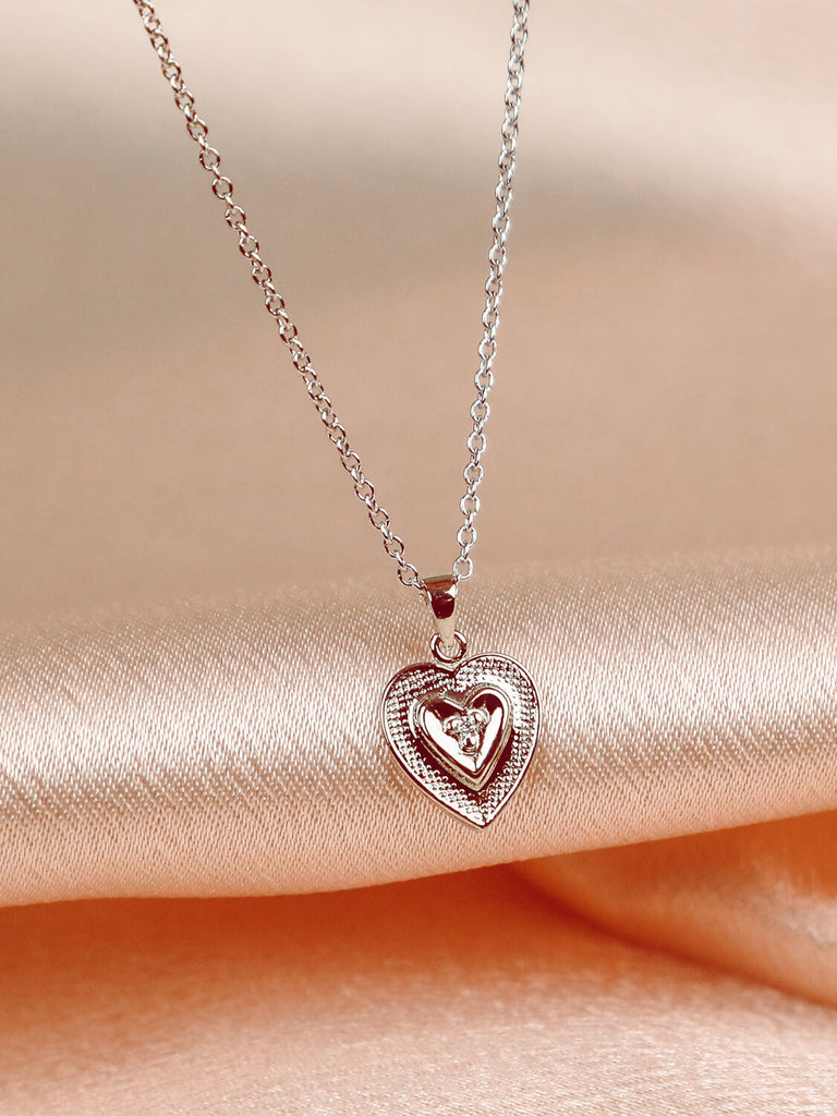 detail shot of true heart necklace in 14k white gold with diamond 