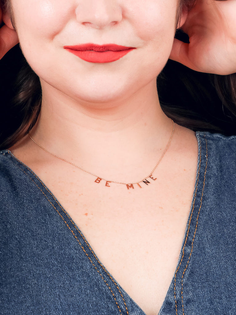 gold Be Mine message necklace on smiling model