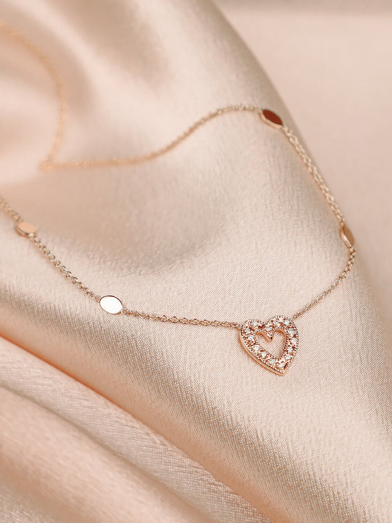 detail photo of charmed heart necklace in 14k rose gold