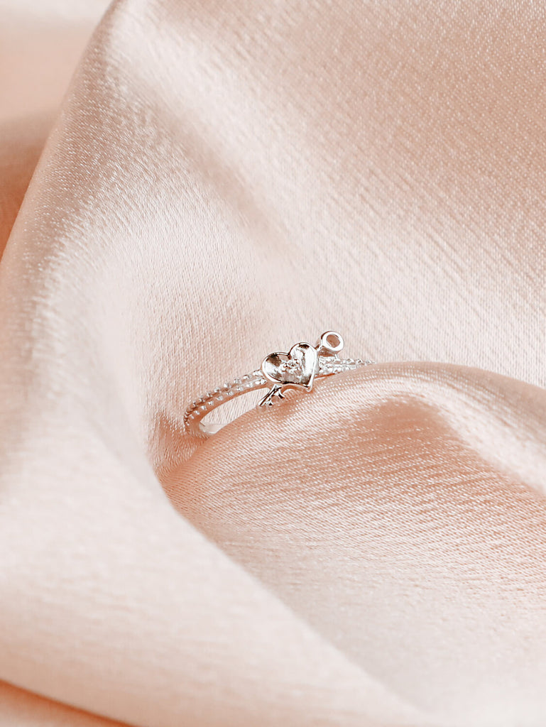 angled photo of woman's diamond love locked ring in 14k white gold