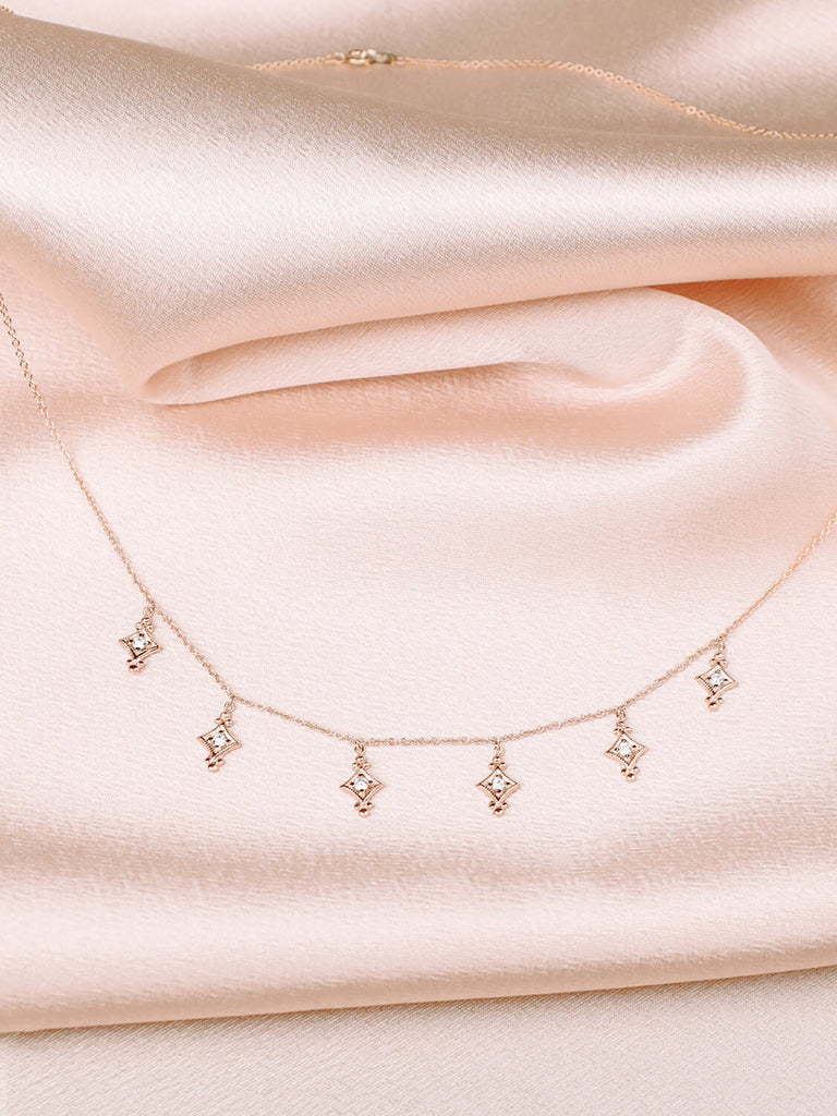 detail photo of evening star necklace with diamonds in 14k yellow gold