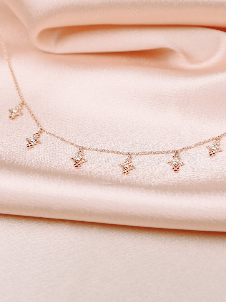 detail photo of evening star necklace with diamonds in 14k yellow gold