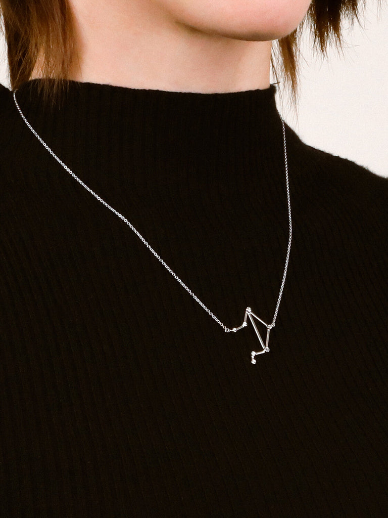 Sterling Silver Libra Constellation necklace on a female model's neck