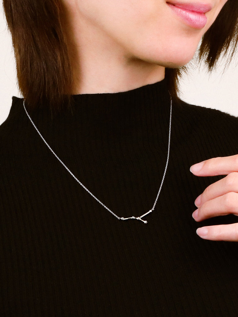 Close detail photo of sterling silver Cancer zodiac constellation necklace from ModSet jewelry on woman's neck