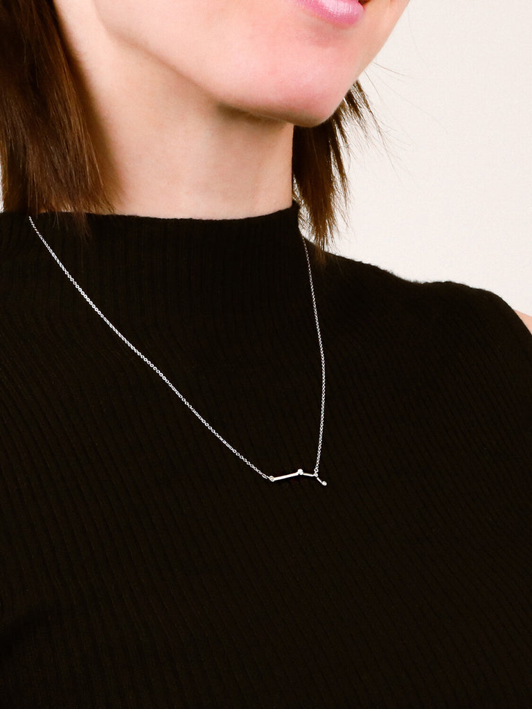 Photo of sterling silver Aries zodiac constellation necklace from ModSet jewelry on a woman's neck