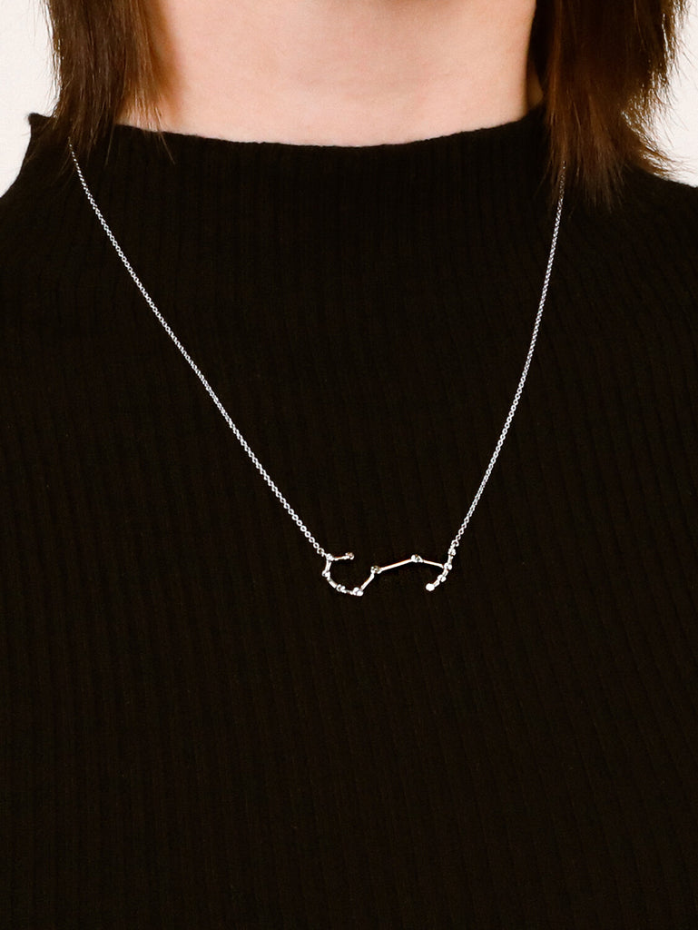 Photo of sterling silver Scorpio zodiac constellation necklace from ModSet jewelry on woman model's neck