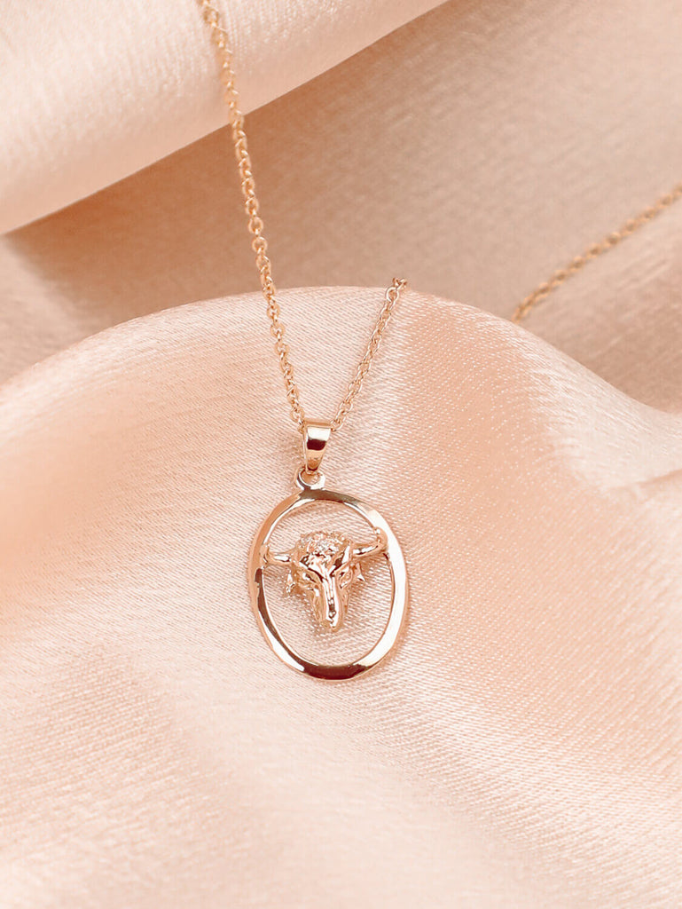 detail photo of taurus zodiac charm necklace with diamonds in 14k yellow gold
