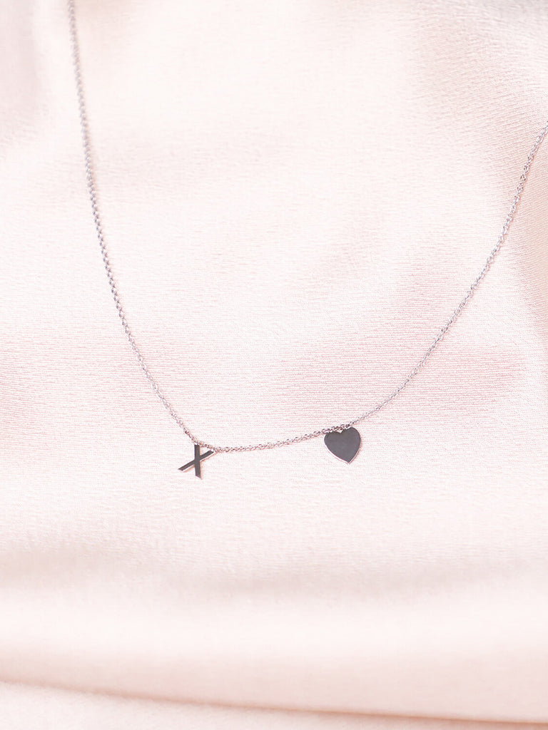 14k White gold XO Love Never Dies necklace against pink satin
